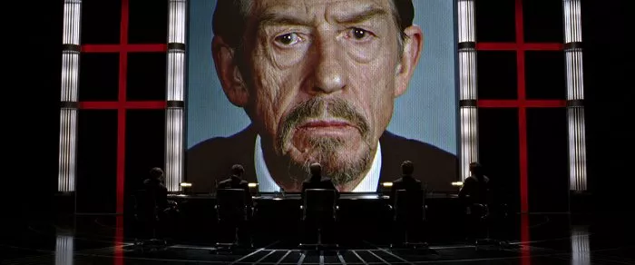 John Hurt (Adam Sutler) Photo © Warner Bros.